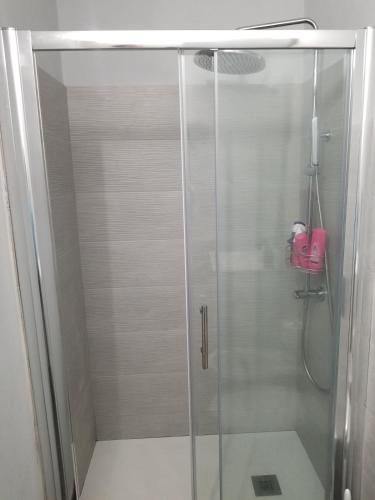 a shower with a glass door in a bathroom at Home on Via degli Dei, Close to Florence in Osteria di Novoli