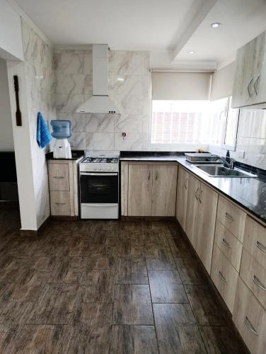 a kitchen with a sink and a stove top oven at Cruz del Sur in Santa Rosa