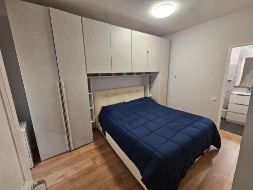 a bedroom with a bed and white cabinets at Home on Via degli Dei, Close to Florence in Osteria di Novoli