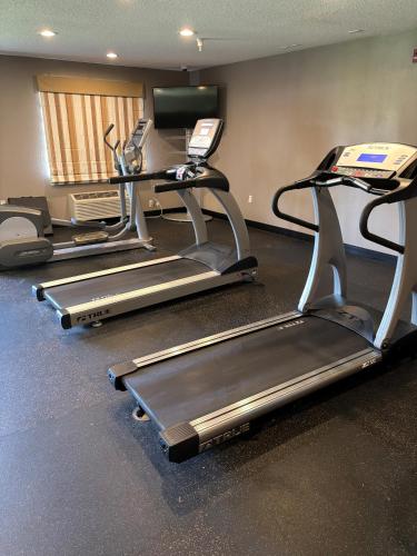 a gym with two tread machines and a treadmill at Baymont by Wyndham Fulton in Fulton