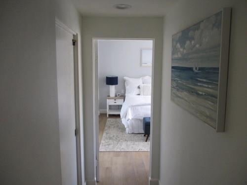 a bedroom with a bed and a picture of the ocean at Saint Ann's Court in Laguna Beach