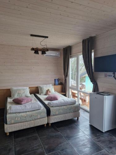 a bedroom with two beds and a window at Къщички Синьо лято, Черноморец - Варна - Blue Summer Houses Varna in Varna City