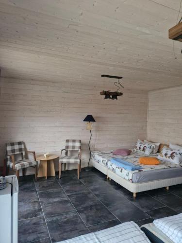 a bedroom with two beds and a table and chairs at Къщички Синьо лято, Черноморец - Варна - Blue Summer Houses Varna in Varna City
