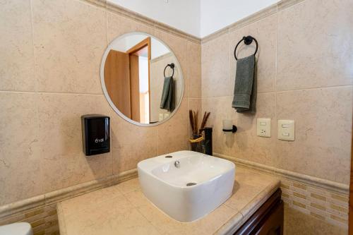 a bathroom with a white sink and a mirror at Casa Ambito in San Raymundo Jalpan