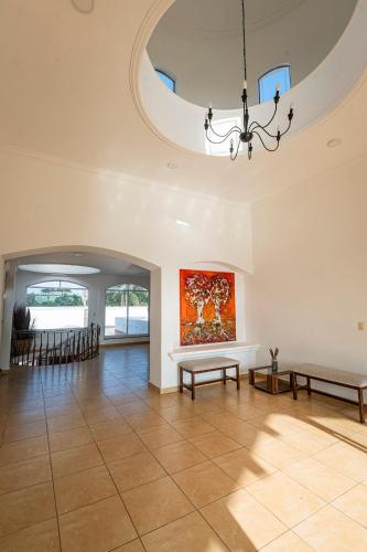 a living room with a table and a painting on the wall at Casa Ambito in San Raymundo Jalpan