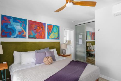 a bedroom with a bed and a ceiling fan at Renovated 3BR House with Heated Pool and Backyard Oasis in San Diego