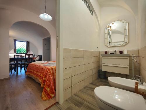 a bathroom with a sink and a toilet and a table at Colline Toscane in Volterra