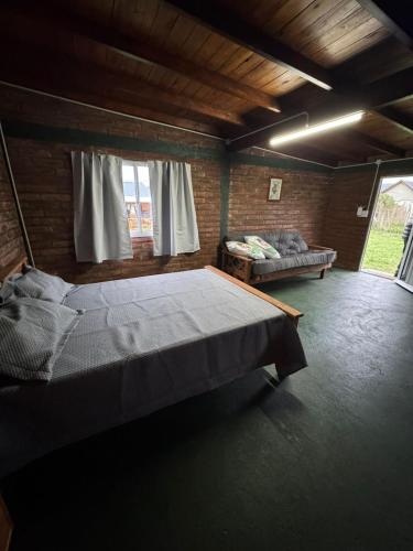 a bedroom with a bed and a couch in a room at OKIN 1 Cobos in Mar de Cobo
