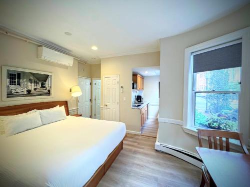 a bedroom with a bed and a table and a window at Copley House in Boston