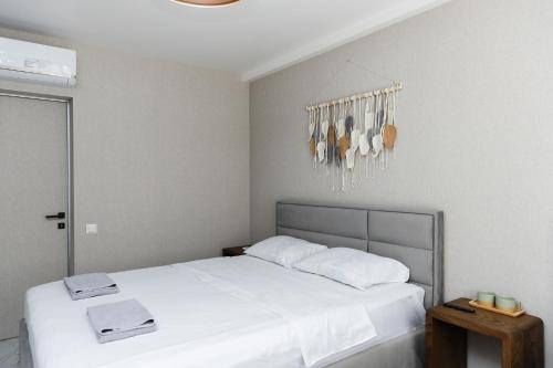 a bedroom with a white bed and a chandelier at 77/5 in Chişinău