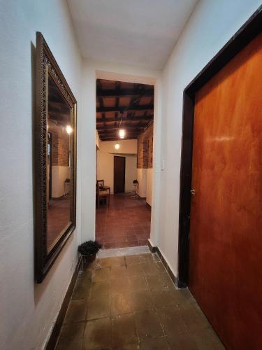 an empty hallway with a wooden door and a room at Cómo en casa, cerca de todo, amplio 100m2 in San Miguel de Tucumán