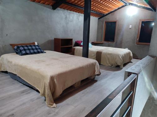 a bedroom with two beds in a room at Casa de campo San Marcos in Pujilí