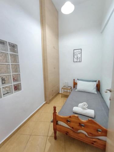 a bedroom with a bed in a room at Pine Apartments in Ermoupoli