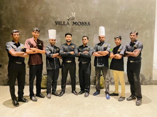 a group of men in uniform posing for a picture at Villa Mossa Ambalangoda Boutique villa in Ambalangoda