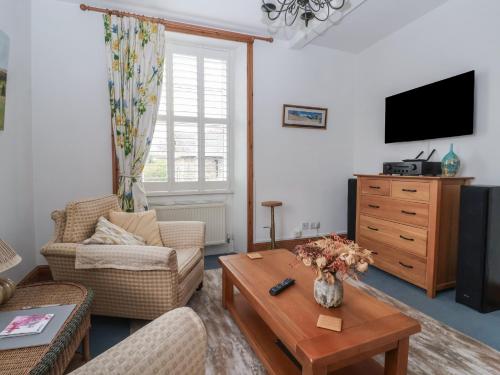 a living room with a couch and a coffee table at Baht'at Cottage in Ilkley
