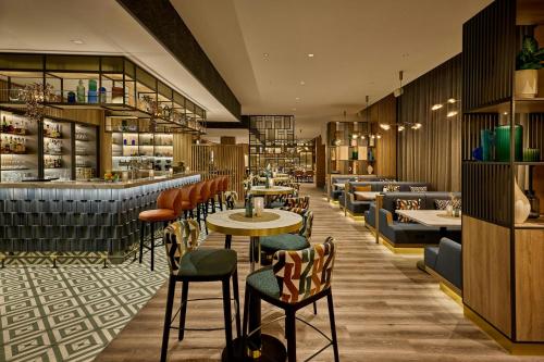 a restaurant with tables and chairs and a bar at Courtyard by Marriott Berlin City Center in Berlin