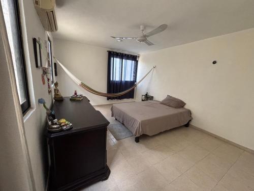 a bedroom with a bed and a window at CASA COLIBRÍ - Solo Mujeres! & lgbt friendly in Mérida