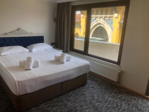 a hotel room with a bed and a large window at Turk Art Hotel in Istanbul