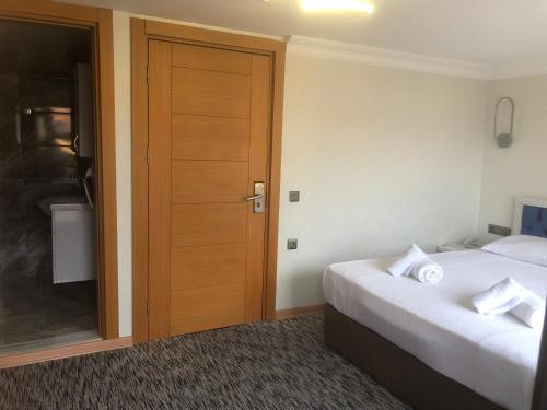 a hotel room with two beds and a door at Turk Art Hotel in Istanbul