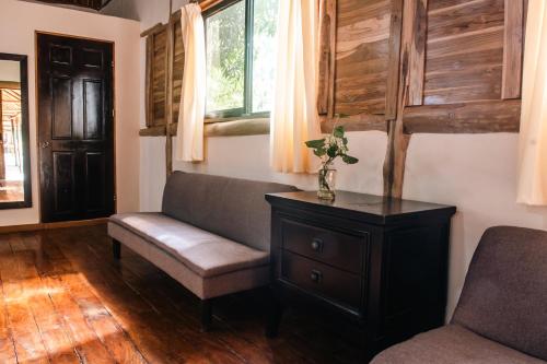 a living room with a couch and a table at Rusteak Living Retreat in natural and peaceful setting in Canafistula in Cañafístula