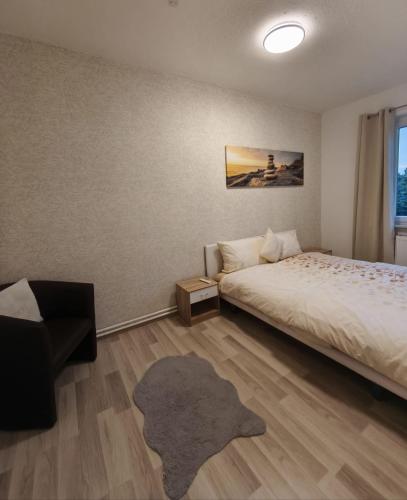 a bedroom with a bed and a rug at FeWo im Harz Bad Harzburg in Bad Harzburg