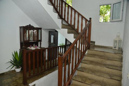 a staircase leading up to a kitchen with a balcony at Hotel Anelli in Skopelos Town