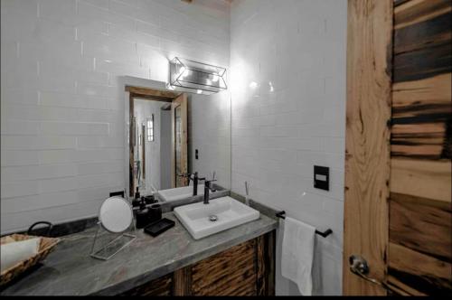 a white bathroom with a sink and a mirror at Casa Paulina in Guanajuato