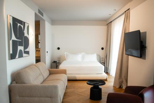 a living room with a bed and a couch at Saint Nicolas Hotel in Himare