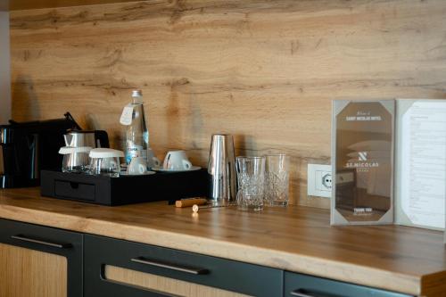 a kitchen counter with a counter top with glasses on it at Saint Nicolas Hotel in Himare