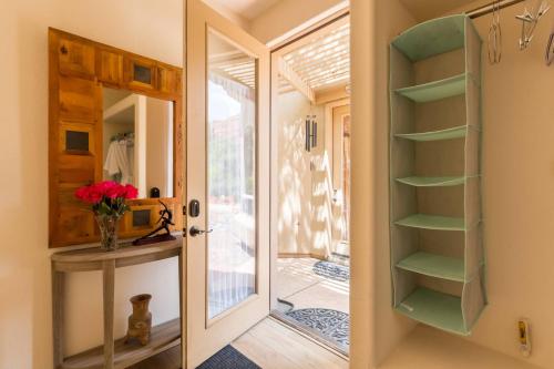a room with a door open to a room with a window at Cozy Sedona Casita with Private Courtyard & Stargazing Hot Tub in Sedona