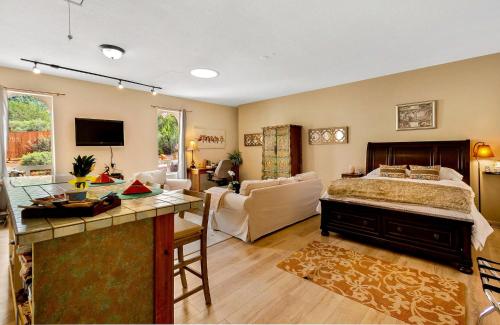a bedroom with a bed and a living room at Cozy Sedona Casita with Private Courtyard & Stargazing Hot Tub in Sedona
