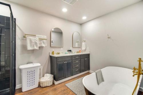 a bathroom with a tub and a sink and mirror at Walk to Marina and Lake Family Retreat in Afton! in Afton