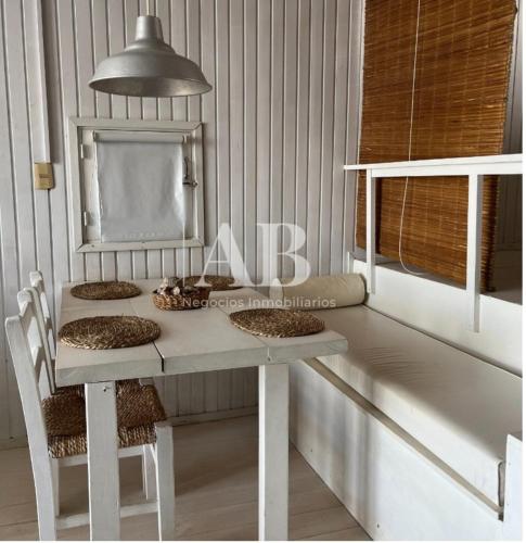 a dining room table with a white table and chairs at La mejor vista del Rivero - Entre Dos Mares - Punat del Diablo in Punta Del Diablo