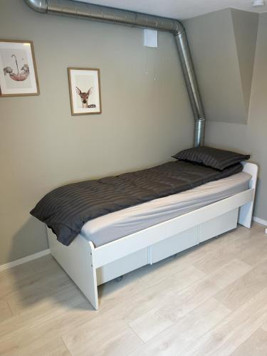 a bed in a room with a metal rail at Large house with 3 bedrooms and a private garden in Stavanger