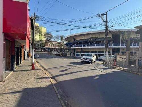 a street with a car driving down the street at Casa NSA - Nossa Senhora Aparecida in Aparecida
