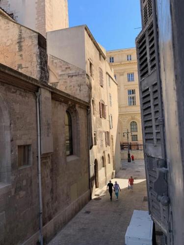 two people walking down a street in an alley at Historique vieux port in Marseille