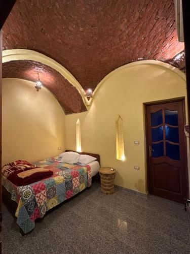 a bedroom with a bed and a door in a room at Rahma house in Kafr ‘Amr