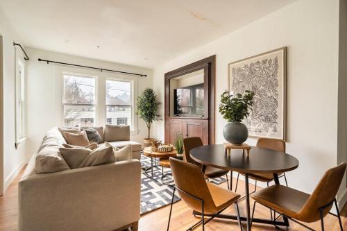 a living room with a couch and a table at Stay Portland - 2BR Flat - Walk to NW 23rd Shops & Cafes in Portland
