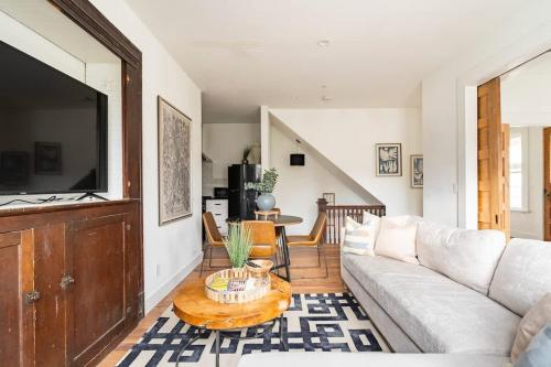 a living room with a couch and a table at Stay Portland - 2BR Flat - Walk to NW 23rd Shops & Cafes in Portland