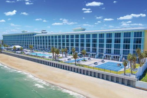 a building on the beach next to the ocean at Grand Seas MOD Collection by Sonesta in Daytona Beach