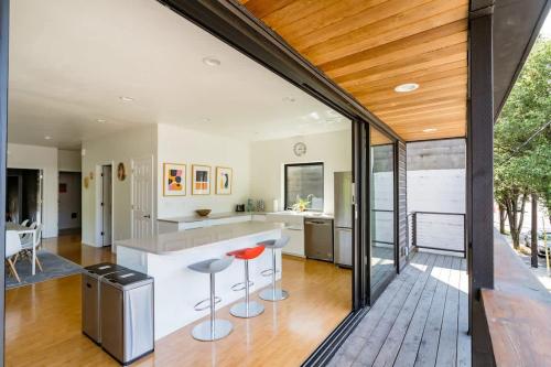 an open kitchen with a bar and stools at Luxurious Portland 3BR in the Pearl District in Portland