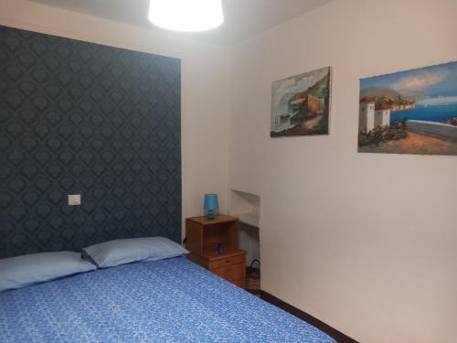 a bedroom with a bed and two pictures on the wall at A casa di Marti in Capodimonte