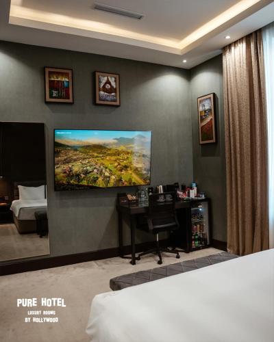 a hotel room with a tv on a wall at Pure Boutique Hotel in Baku