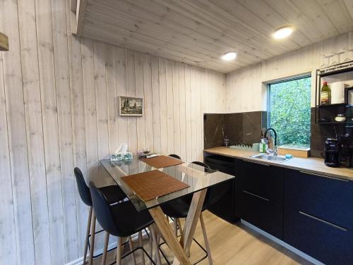 a kitchen with a table and chairs and a sink at Metsamarja in Rässa