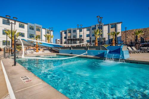 a swimming pool with a water slide in a resort at Coral Springs Resort H2 Brand New Home, Community Pool, Outdoor Fireplace, and Near Sand Hollow in Washington