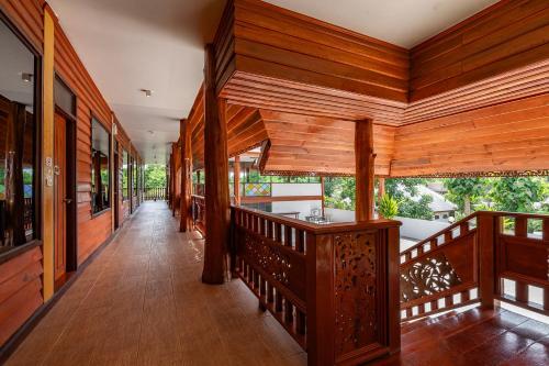 a hallway of a house with wooden walls and wooden floors at Romsak Lanna Resort in Chiang Mai