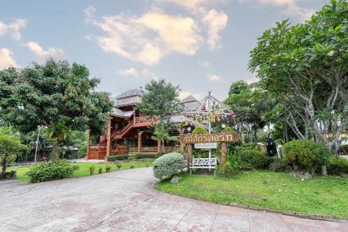 a resort with a sign in front of a building at Romsak Lanna Resort in Chiang Mai