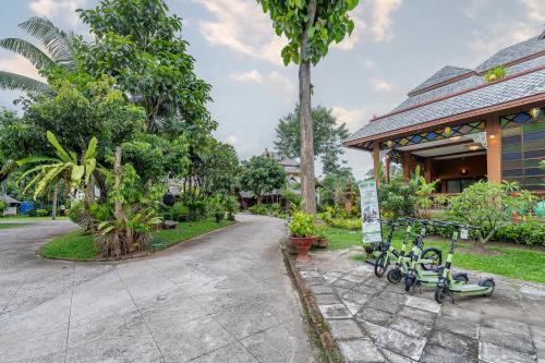 a house with bikes parked outside of it at Romsak Lanna Resort in Chiang Mai