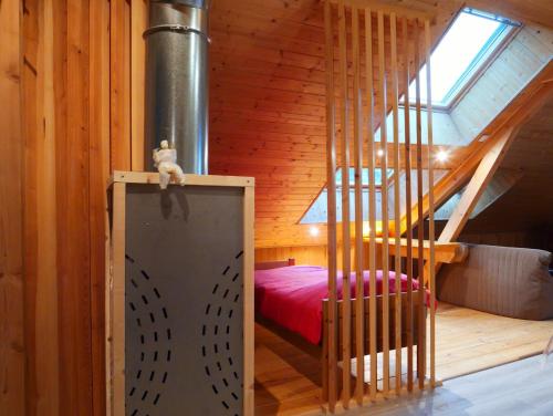 a small room with a bed and a staircase at Etage Bleu à la montagne in Saint-Julien-en-Champsaur