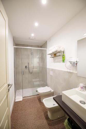 a bathroom with a shower and a toilet and a sink at Dimora Don Ciccillo B&B in Bagnara Calabra